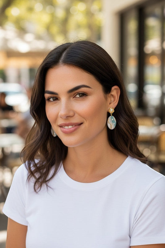 Lakelynns Designs oval dangle earrings with pearl accents, featuring aqua, cream, and gold marbled design.