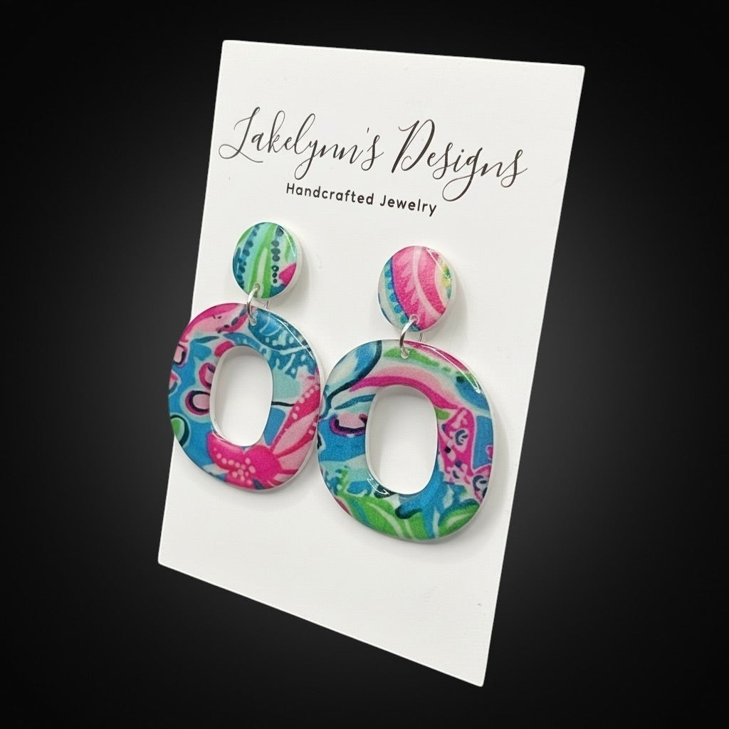 Lakelynns Designs oval hoop earrings with colorful blue, pink, and green floral pattern. Circular stud top.