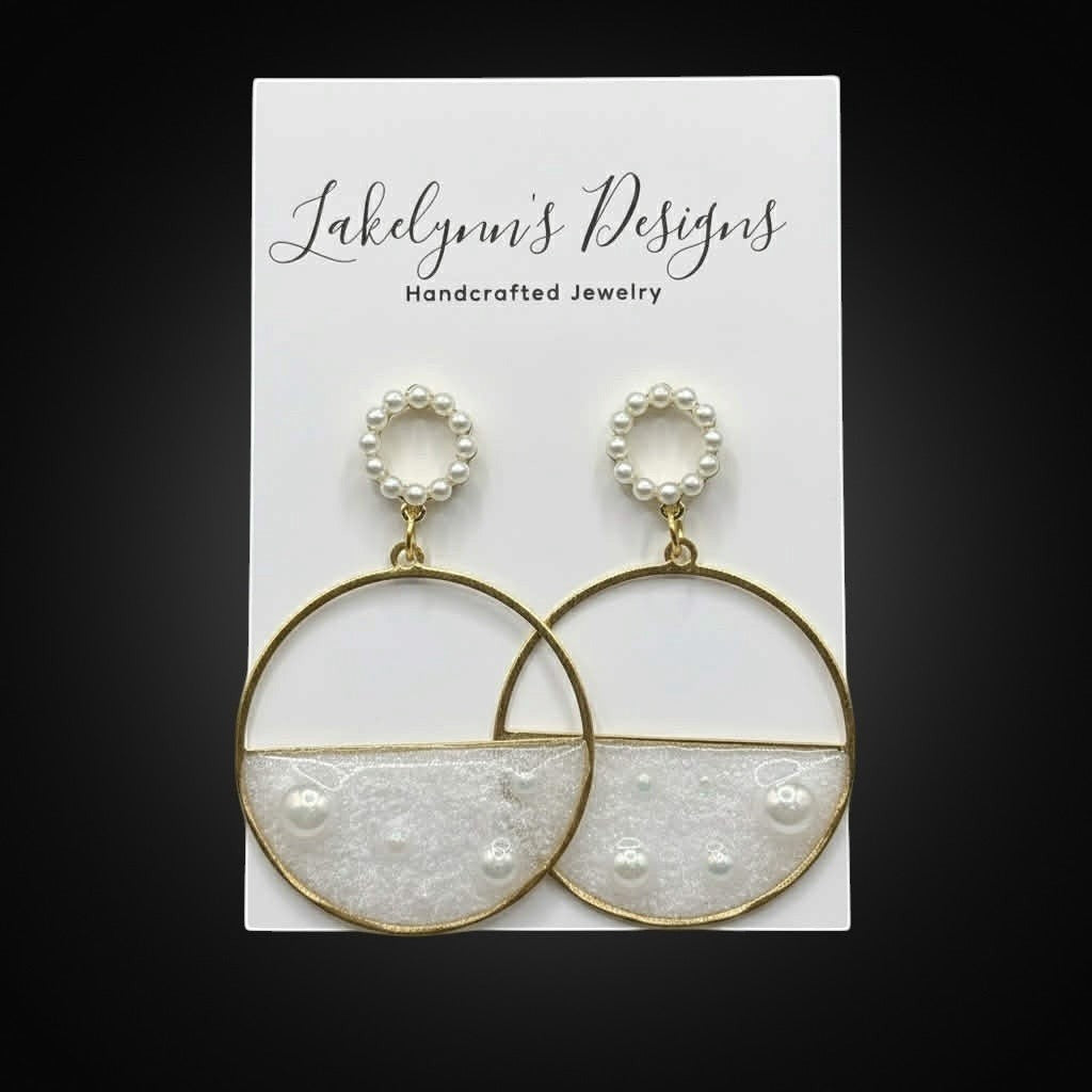 Lakelynns Designs gold-tone hoop dangle earrings with white resin and faux pearls. Circular stud tops.