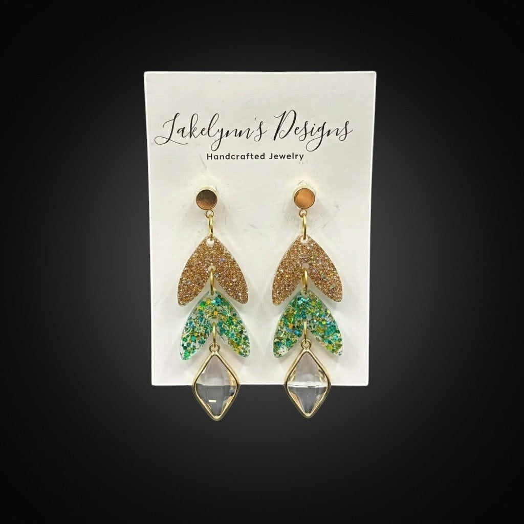 Lakelynns Designs Quinn Dangle Leaf Earrings with gold glitter top leaf and green/teal glitter lower leaves, clear diamond charm.