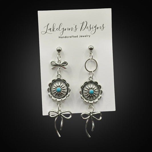 Lakelynns Designs silver Southwestern bow dangle earrings with turquoise concho stones.