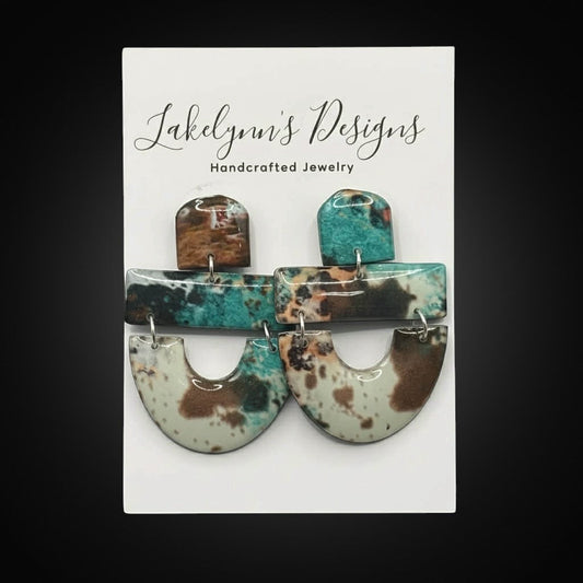 Lakelynns Designs Southwestern inspired dangle earrings in brown, turquoise, and white with layered U-shaped drops.