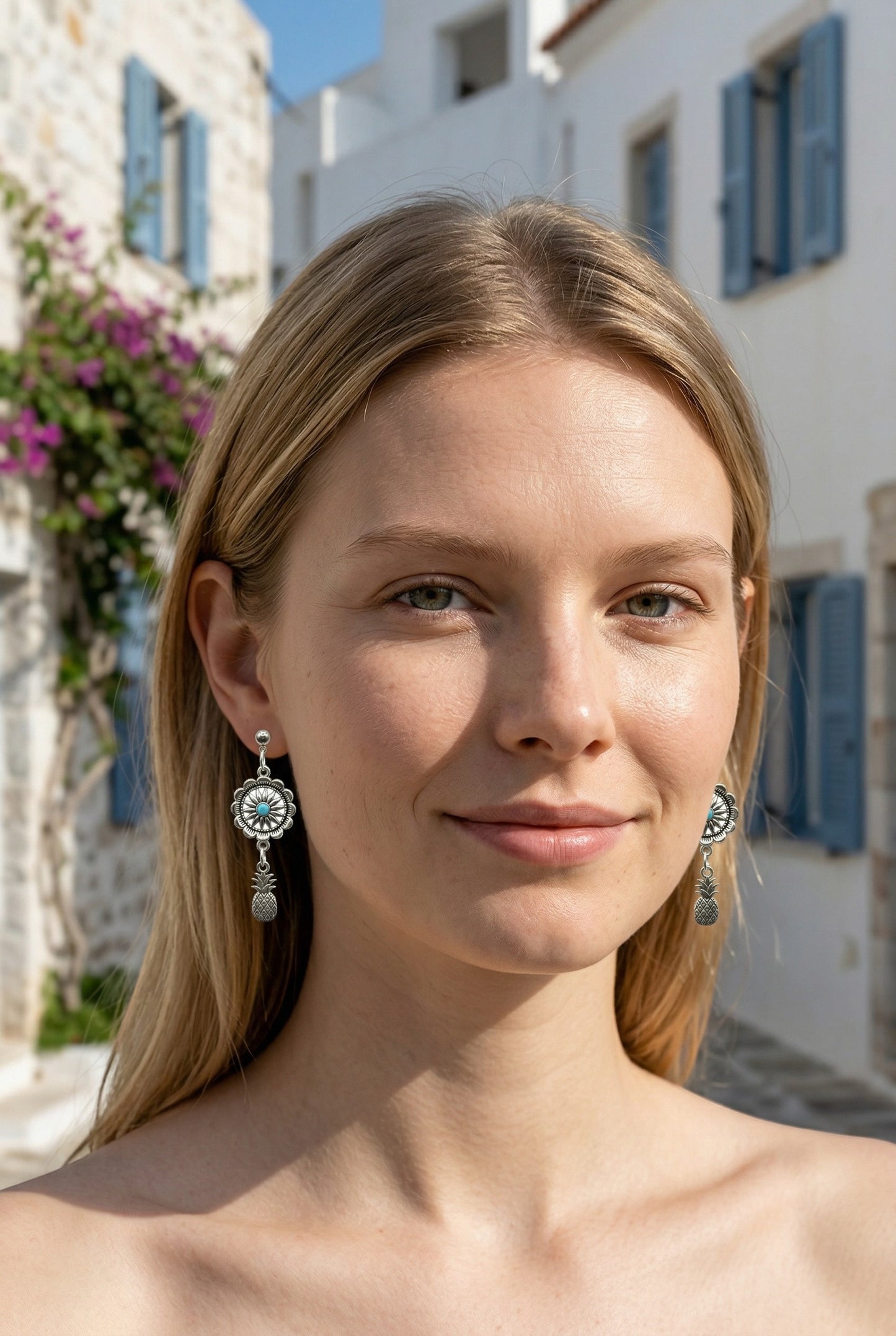 Lakelynns Designs silver-tone dangle earrings with concho design, turquoise center, and pineapple charm.
