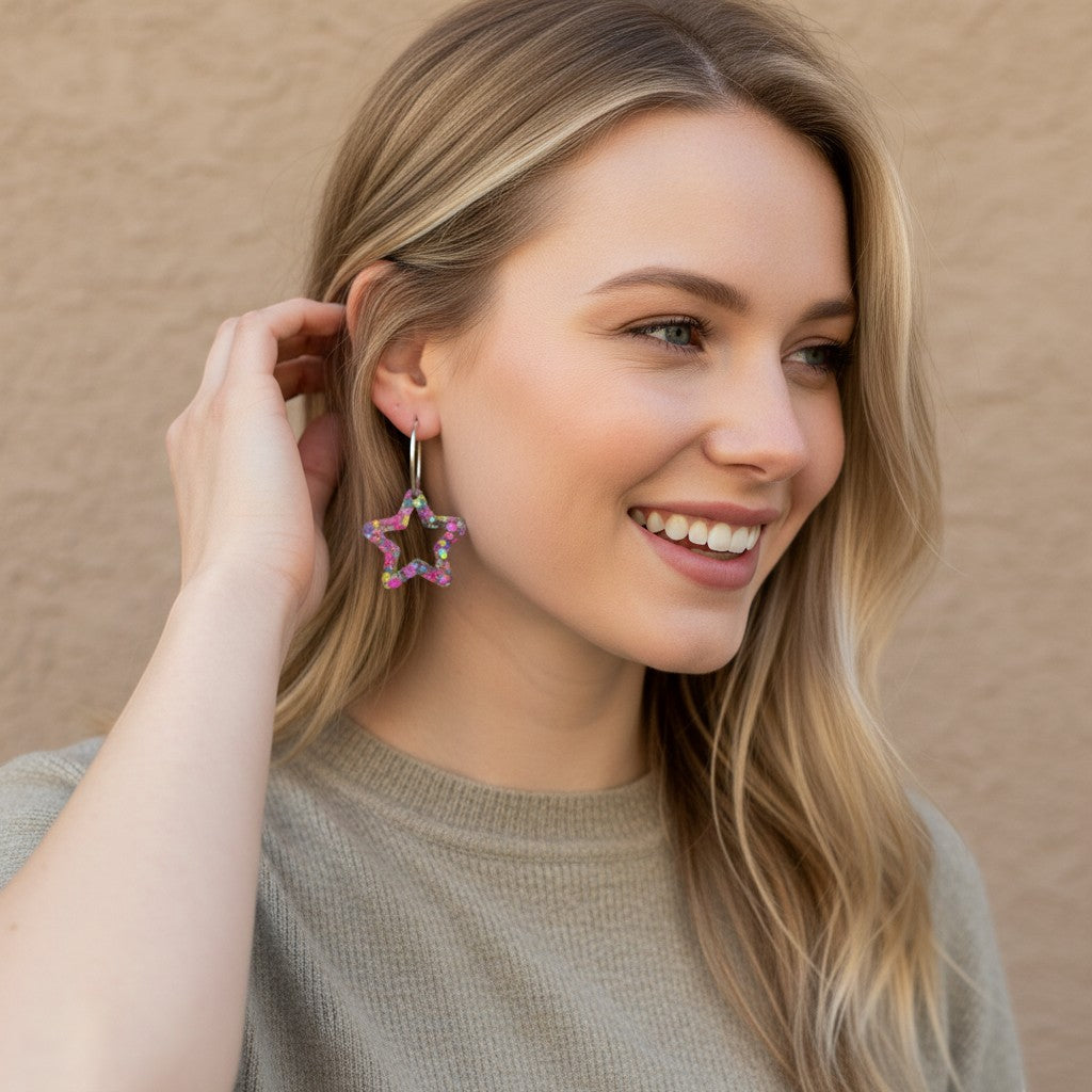 Lakelynns Designs Lorelai Star Shaped Glitter Hoop Earrings with pink, purple, green, and black glitter in clear resin.