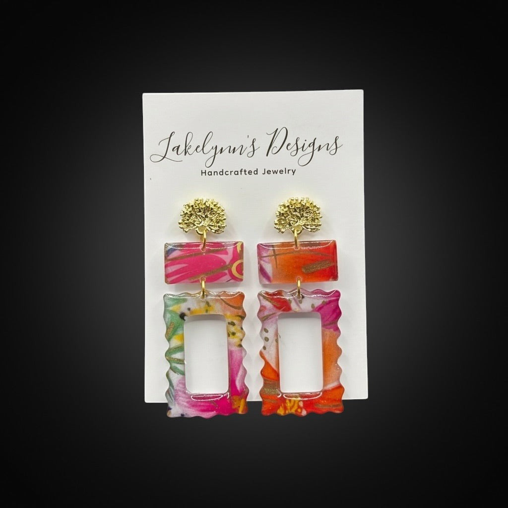 Lakelynns Designs Rectangular Statement Earrings with gold-tone stud tops, featuring vibrant pink, orange, and green patterns on a translucent background.