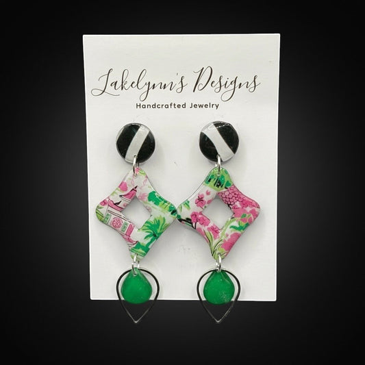 Lakelynns Designs statement earrings with black and white striped studs, floral print diamond shapes, and emerald green teardrop beads.