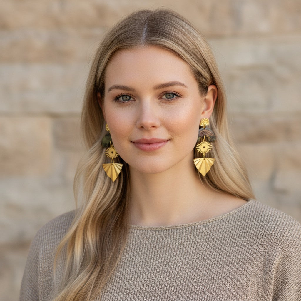 Lakelynns Designs layered statement earrings with patterned arch, sunburst, and fan shapes in gold-tone, green, brown, and burgundy.