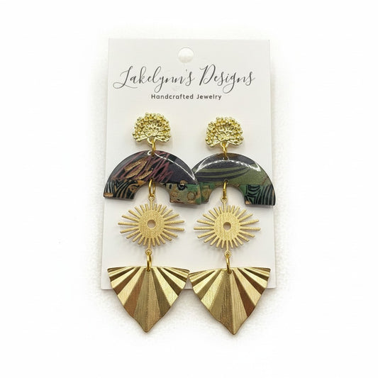 Lakelynns Designs layered statement earrings with gold-tone studs, sunbursts, and fan shapes. Patterned arch tops in green, brown, and burgundy.