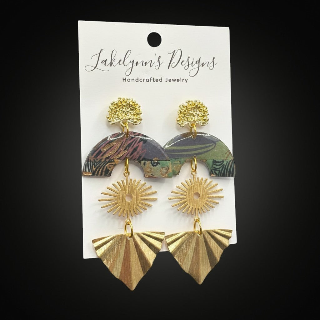 Lakelynns Designs layered statement earrings with patterned arch, sunburst, and fan shapes in green, brown, burgundy, and gold.