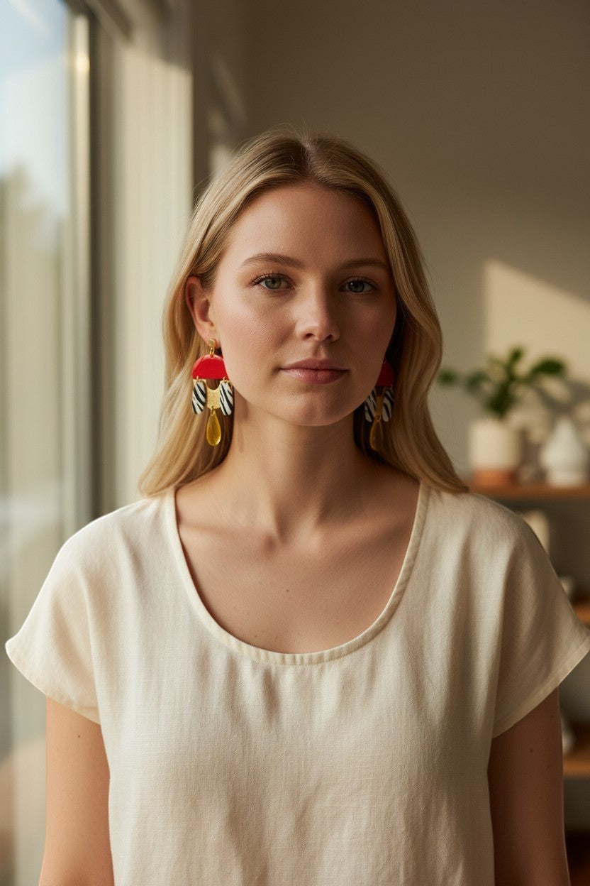 Lakelynns Designs abstract statement earrings with red, black, white zebra print, gold accents, and yellow teardrop charms.