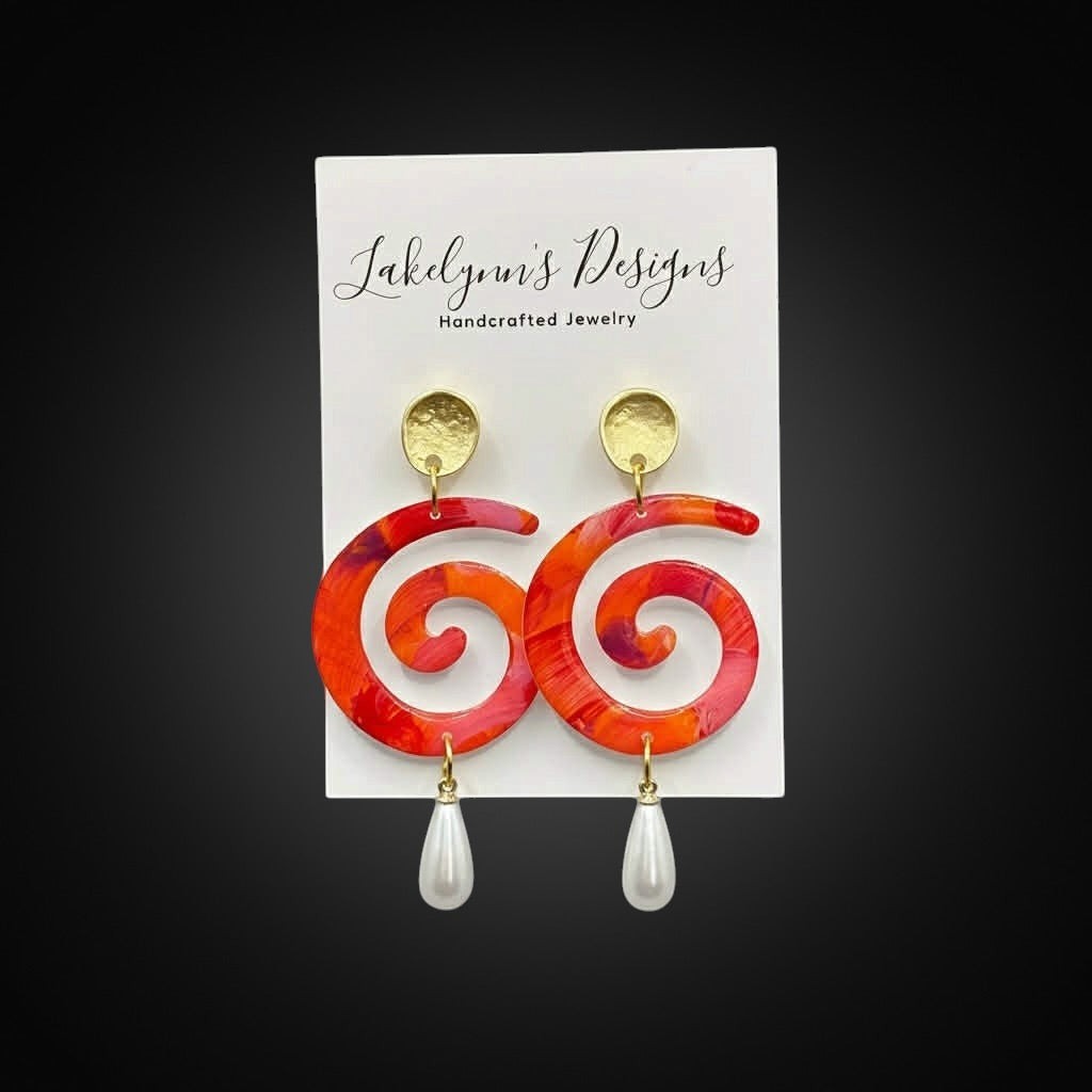 Lakelynns Designs Emi Swirl Drop Earrings with faux pearl accent, marbled red, orange, and pink acrylic.