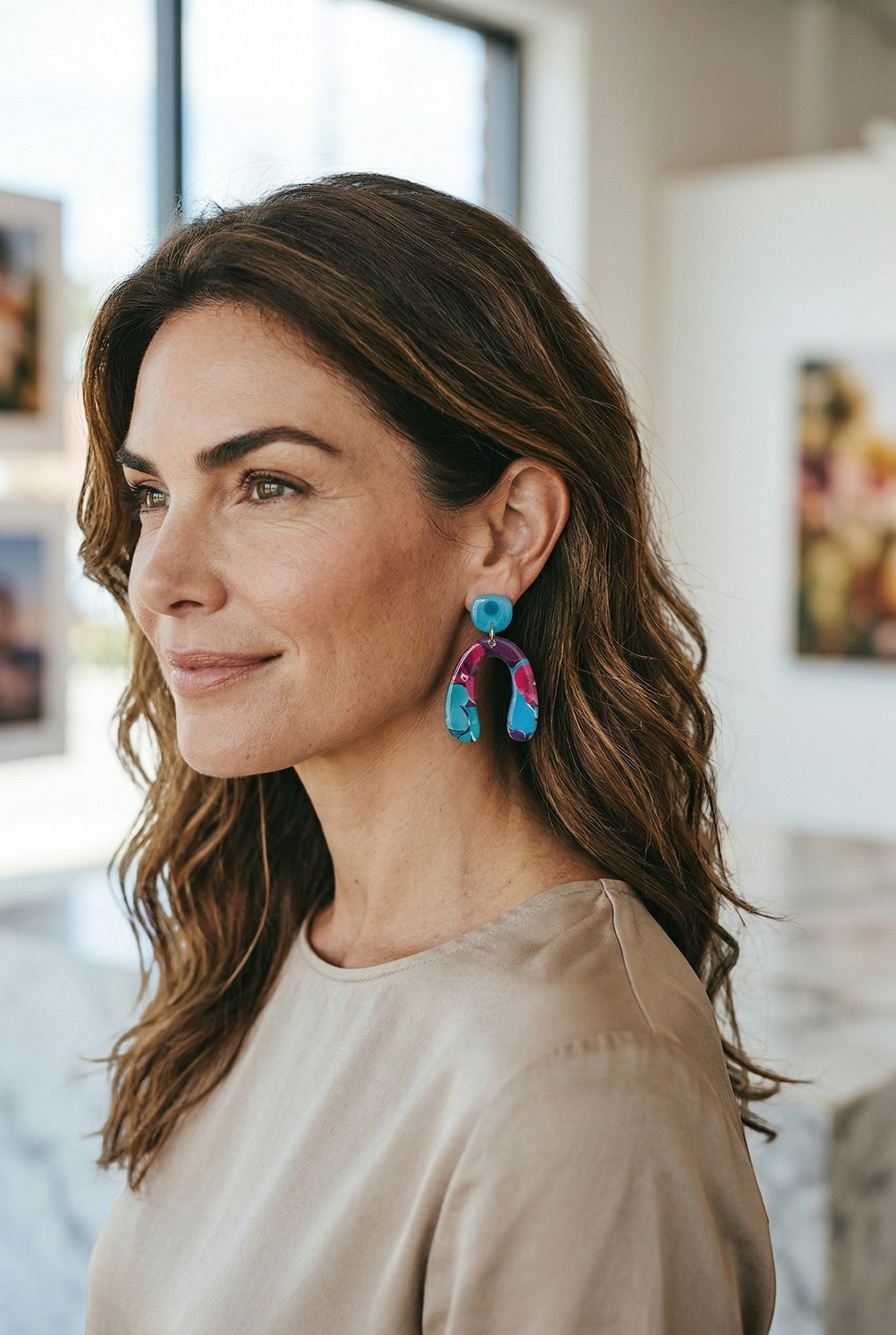 Lakelynns Designs vibrant abstract arch dangle earrings in pink, blue, and purple with a glossy finish.