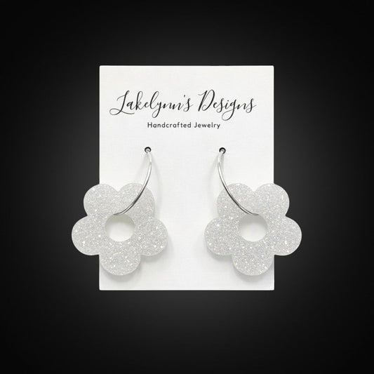 Lakelynns Designs white glitter acrylic flower hoop earrings with silver-tone hoops.