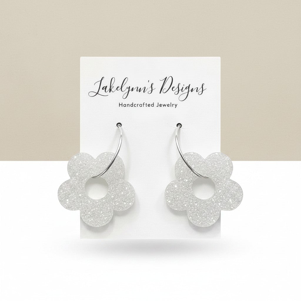 Lakelynns Designs white glitter acrylic flower hoop earrings with silver-tone hoops.