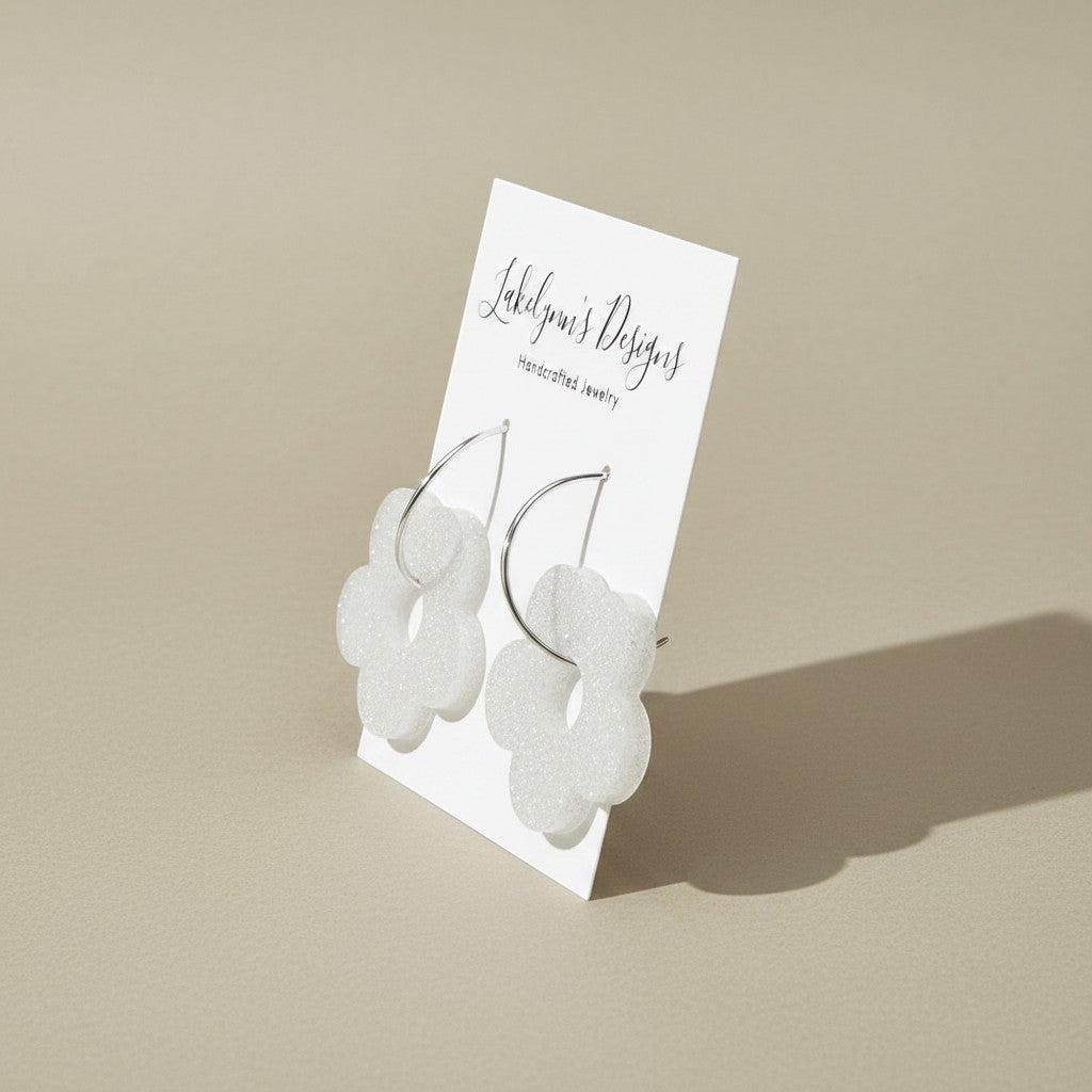 Lakelynns Designs white glitter acrylic flower hoop earrings with silver-tone hoops.