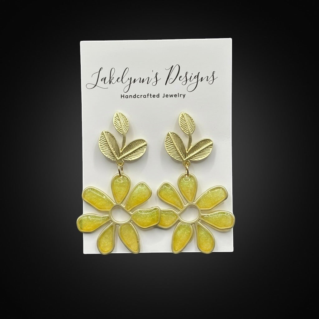 Lakelynns Designs yellow daisy flower dangle earrings with gold-tone leaves and stems.